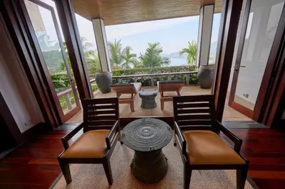 a room with chairs and a table with a view of the ocean at Villa 29 Montebello Andara Resort Villas in Kamala Beach