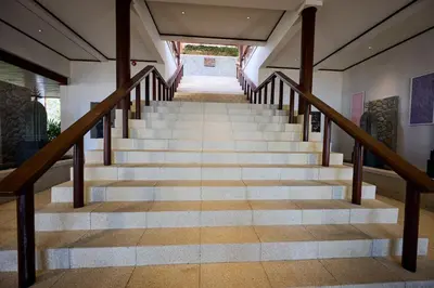 a staircase in a house with wooden railings at Villa 29 Montebello Andara Resort Villas in Kamala Beach