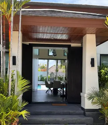 an open entryway to a house with a table at Pool Villa - 3 Bedroom- Walking to Bangtao Beach, Restaurants and Supermarkets in Bang Tao Beach