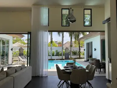 a living room with a couch and a table and a pool at Pool Villa - 3 Bedroom- Walking to Bangtao Beach, Restaurants and Supermarkets in Bang Tao Beach