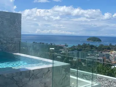 a view of the ocean from a building with a swimming pool at The View Luxury Condominium Karon in Kata Beach