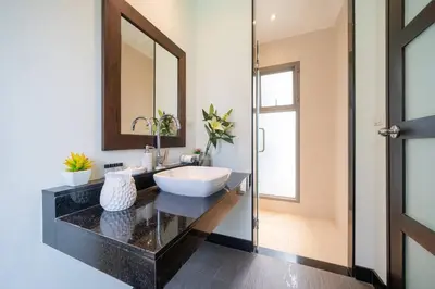 a bathroom with a sink and a mirror at 3 bedrooms private villa with garden Rawai in Phuket Town