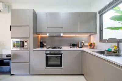 a kitchen with stainless steel appliances and a window at 3 bedrooms private villa with garden Rawai in Phuket Town