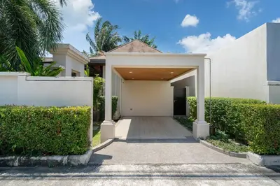 a white house with a gate and a driveway at 3 bedrooms private villa with garden Rawai in Phuket Town