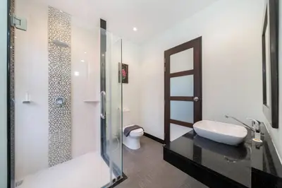 a bathroom with a glass shower and a toilet at 3 bedrooms private villa with garden Rawai in Phuket Town