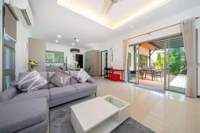a living room with a couch and a table at 3 bedrooms private villa with garden Rawai in Phuket Town