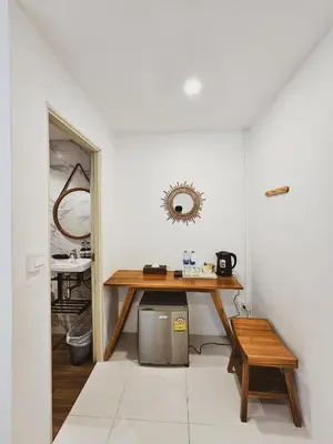 a dining room with a table and a mirror at BB Hidden House in Phi Phi Don