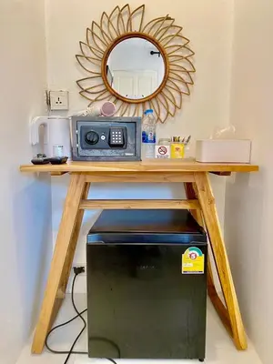 a table with a microwave and a mirror at BB Hidden House in Phi Phi Don
