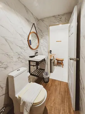 a bathroom with a toilet and a sink and a mirror at BB Hidden House in Phi Phi Don