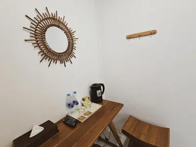a room with a table and a mirror on the wall at BB Hidden House in Phi Phi Don