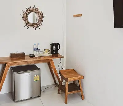 a room with a table and a stool and a table with a mirror at BB Hidden House in Phi Phi Don