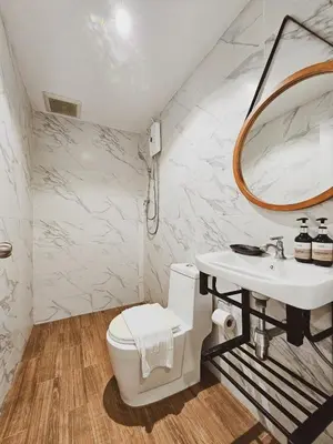 a bathroom with a sink and a toilet and a mirror at BB Hidden House in Phi Phi Don