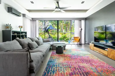 a living room with a couch and a rug at Laguna Park 4 Bedrooms Villa by NLA in Phuket Town