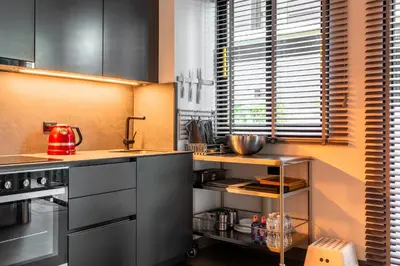 a kitchen with black cabinets and a red appliance at Laguna Park 4 Bedrooms Villa by NLA in Phuket Town