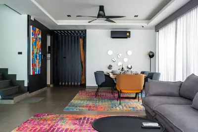 a living room with a couch and a table at Laguna Park 4 Bedrooms Villa by NLA in Phuket Town