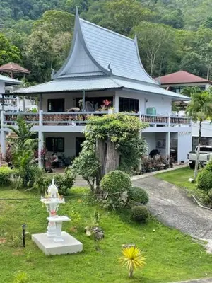 a large white house with a roof at Grand Luxe Kamala in Kamala Beach