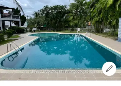 a large swimming pool with blue water at Grand Luxe Kamala in Kamala Beach