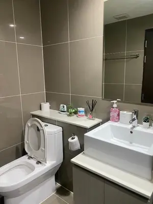 a bathroom with a sink and a toilet and a mirror at Centrio Condominiums Top Floor with Pool and Garden view in Ban Na Khua