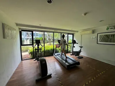 a person walking on a treadmill in a gym at Centrio Condominiums Top Floor with Pool and Garden view in Ban Na Khua
