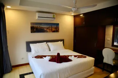 a bedroom with a large white bed with two white towels at 4-5 bedroom Villa At Kamala Beach, Pool in Kamala Beach