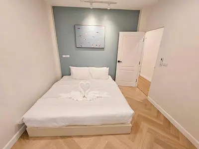 a small bedroom with a bed with a flower on it at Baan 112 Patong in Patong Beach