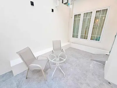 two chairs and a table in a room at Baan 112 Patong in Patong Beach