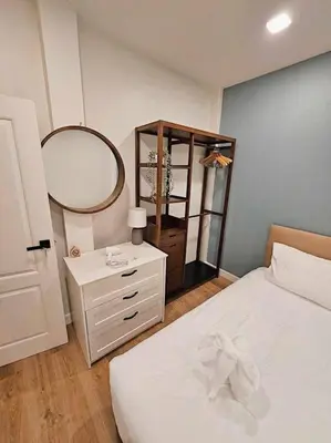 a bedroom with a white bed and a mirror at Baan 112 Patong in Patong Beach
