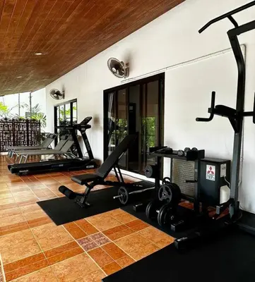 a gym with several treadmills and exercise bikes at Coconut Palms huge swimming pool and pool table V136 in Rawai Beach