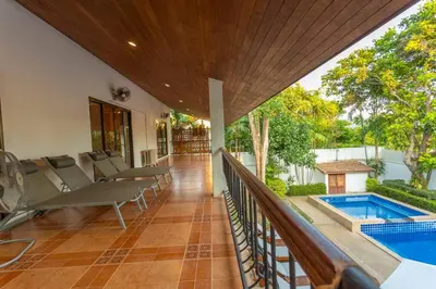 a balcony with chairs and a swimming pool at Coconut Palms huge swimming pool and pool table V136 in Rawai Beach