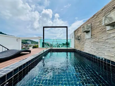 a swimming pool in the middle of a house at Kamala Regent by RESAVA in Kamala Beach