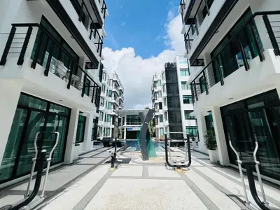 an empty street in a city with tall buildings at Kamala Regent by RESAVA in Kamala Beach