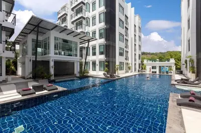 a swimming pool in the middle of a building at Kamala Regent by RESAVA in Kamala Beach