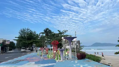 a street with a bunch of chairs on the beach at Patong Vacation Condos by Pam - 28 SQM modern condos with private bathroom, kitchen, King Bed, free WiFi and 65 inch smart TC in Patong Beach