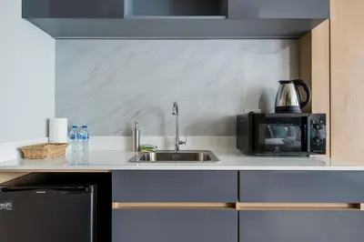 a kitchen with a sink and a microwave at WEG NaiThon Beach in Nai Thon Beach