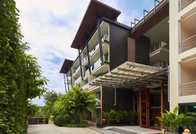 an exterior view of a building with awnings at At the Tree bright studio by Lofty in Rawai Beach