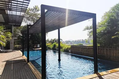 a swimming pool with a pergola in a house at At the Tree bright studio by Lofty in Rawai Beach