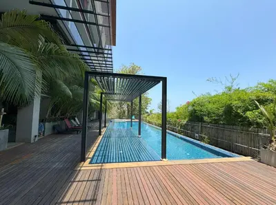 a swimming pool next to a building at At the Tree bright studio by Lofty in Rawai Beach