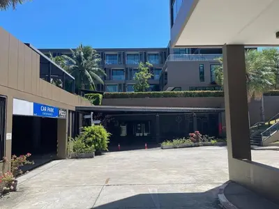 an empty parking lot in front of a building at The Pixel Cape Panwa Beach Condo in Panwa Beach