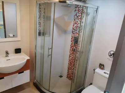 a bathroom with a shower and a sink at The Pixel Cape Panwa Beach Condo in Panwa Beach