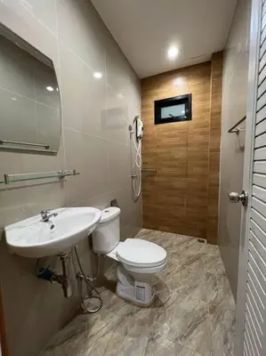 a bathroom with a toilet and a sink at Studio Apartment 12 in Thalang in Ban Phak Chit