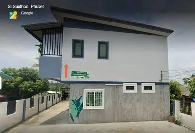 a small building with a window on the side of it at Studio Apartment 12 in Thalang in Ban Phak Chit