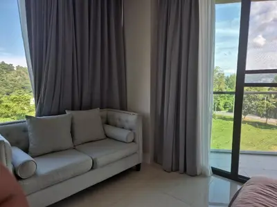 a living room with a couch in front of a window at The viva patong condo C602 in Patong Beach
