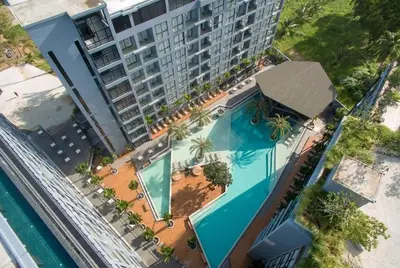 an overhead view of a swimming pool in front of a building at Citygate serviced apartments Kamala beach, rooftop pool and gym P311 in Kamala Beach