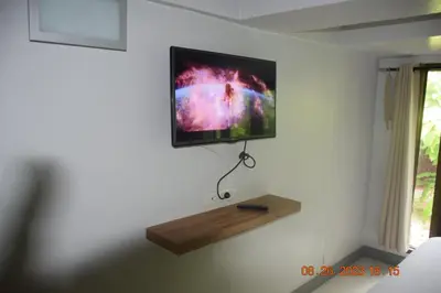 a flat screen tv hanging on a wall at Kalim Residence in Patong Beach