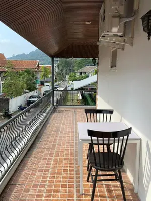 a patio with two chairs and a table on a balcony at Mipiace in Kamala Beach