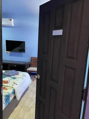 a door leading to a bedroom with a bed at Mipiace in Kamala Beach