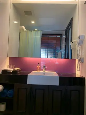 a bathroom with a sink and a large mirror at Luxury Suite Room by Atlas X in Kata Beach