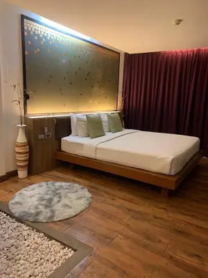 a bedroom with a bed with a large window at Luxury Suite Room by Atlas X in Kata Beach