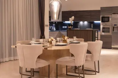 a dining room table with chairs and a kitchen at Do You Want Luxury Sea views With Beach Access V38 in Rawai Beach