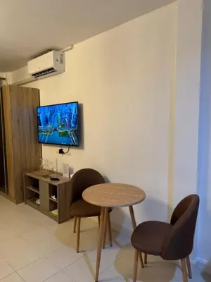 a room with a table and two chairs and a tv at Apartments Kata Beach in Kata Beach